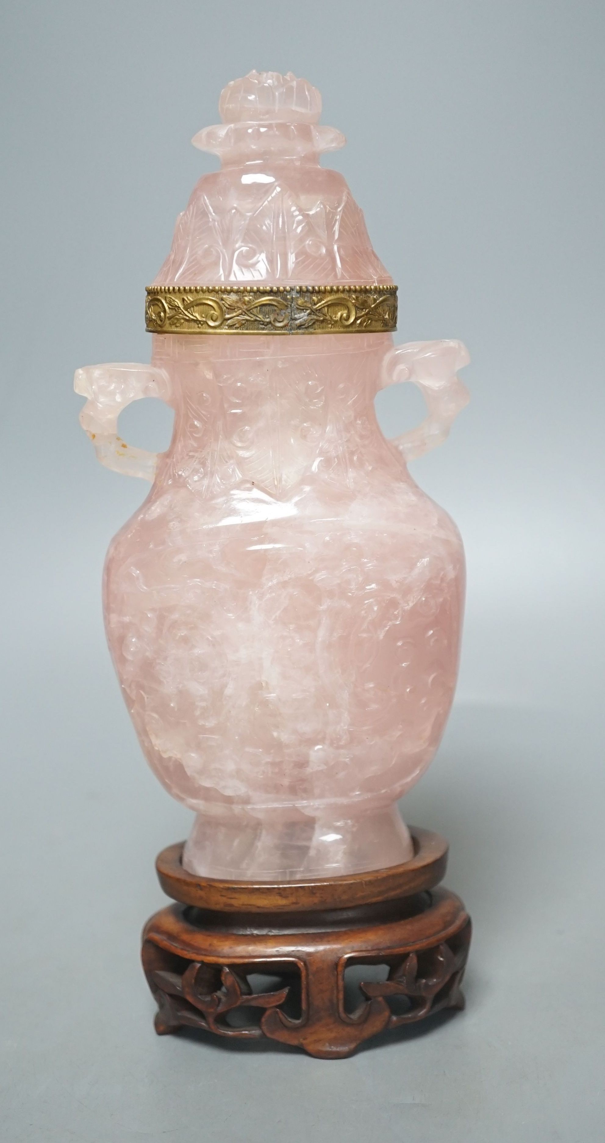 A late 19th/early 20th century Chinese carved rose quartz vase and cover, on a Hongmu stand, 23.5 cm high including stand.